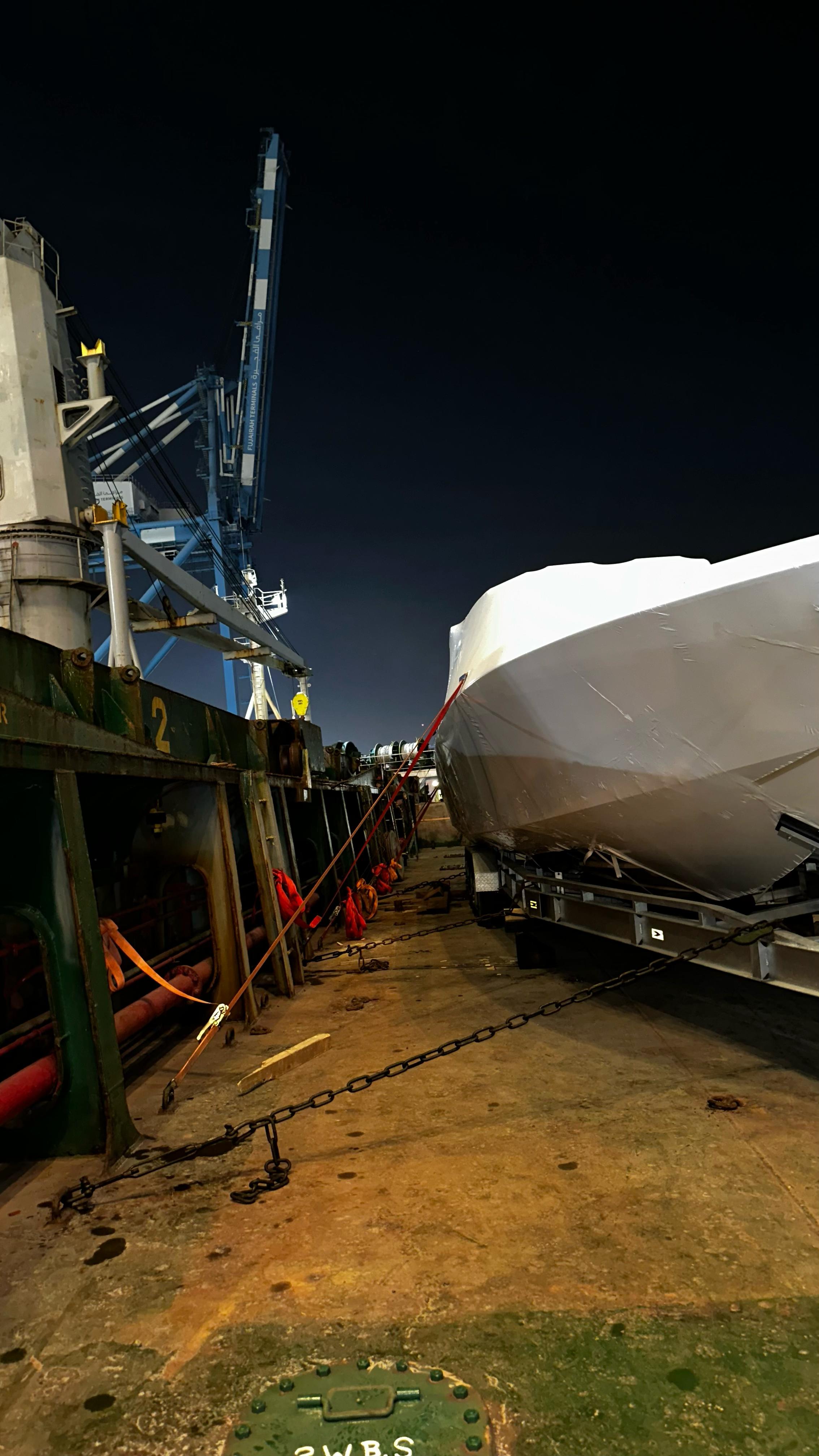 Wrapped boat alongside deck equipment and lifting slings