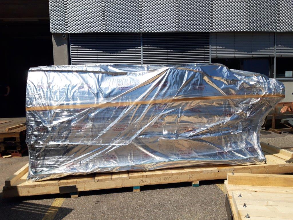 Industrial machinery beside packing materials at a preparation area