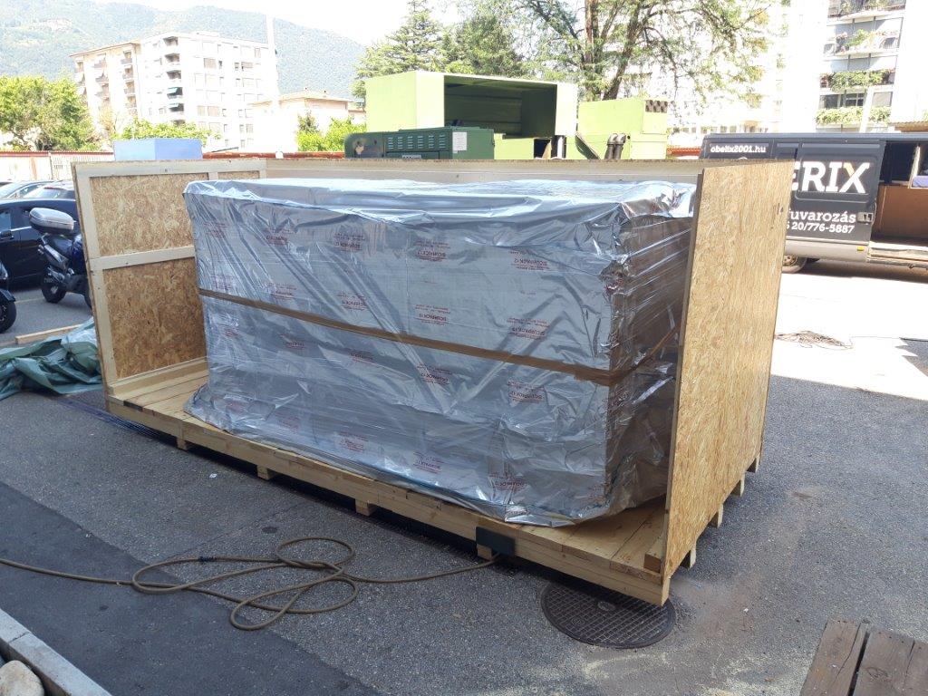Wrapped machinery supported by a timber base with side protection